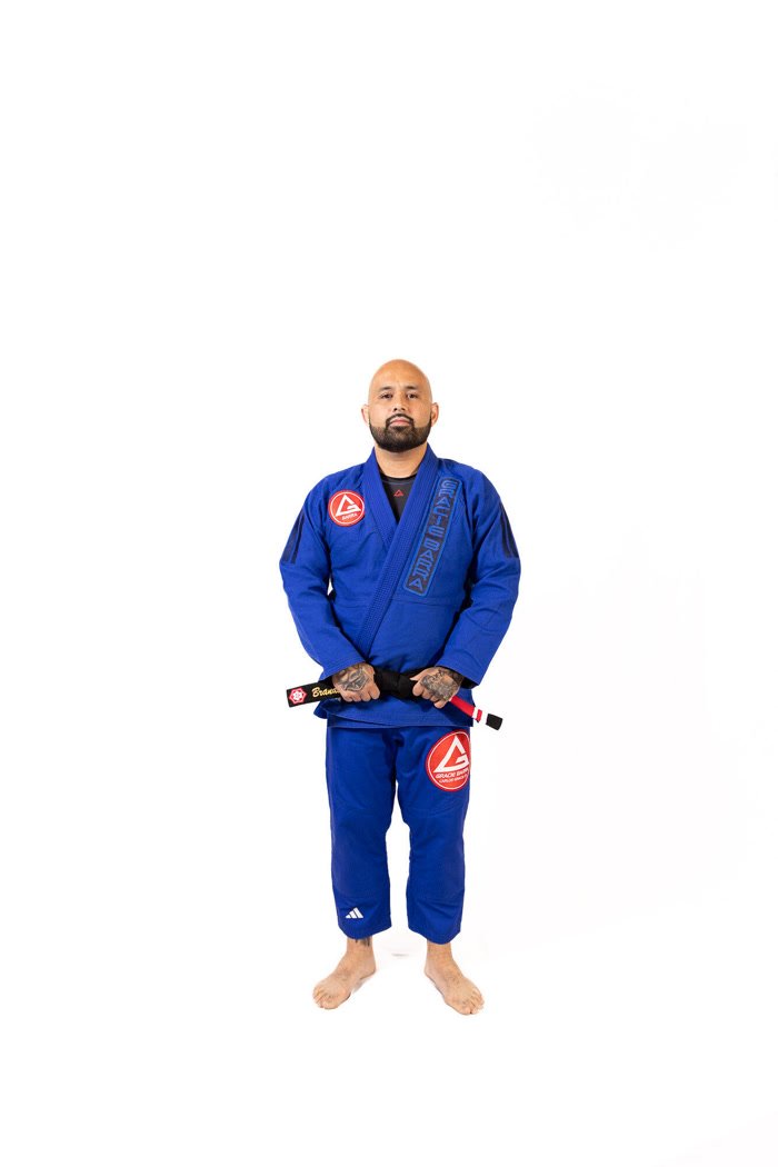 Professor Brandon Belsky in a blue gi with a black belt