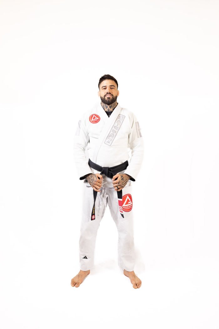 Professor Mair Amaral in a white gi with a black belt